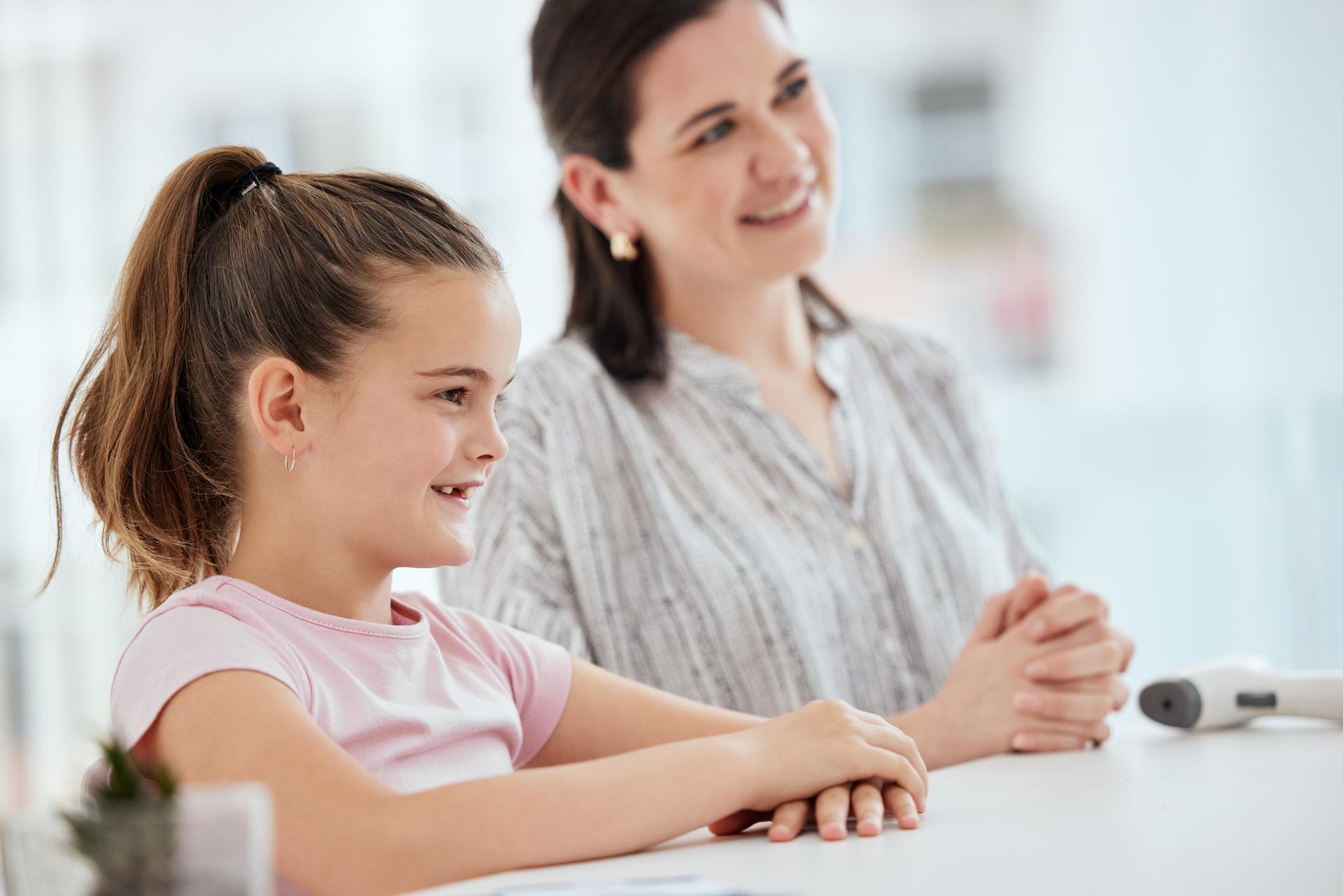 Shot of a mother and daughter at a checkup at a hospital