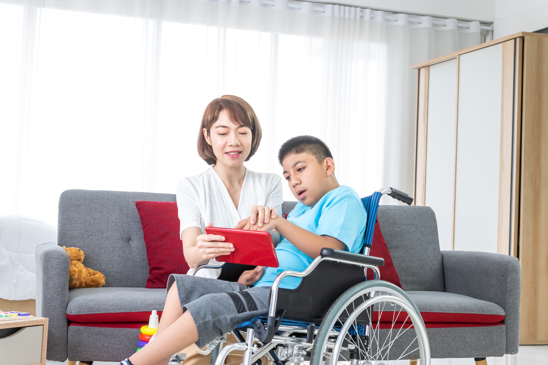 woman playing with disabled child